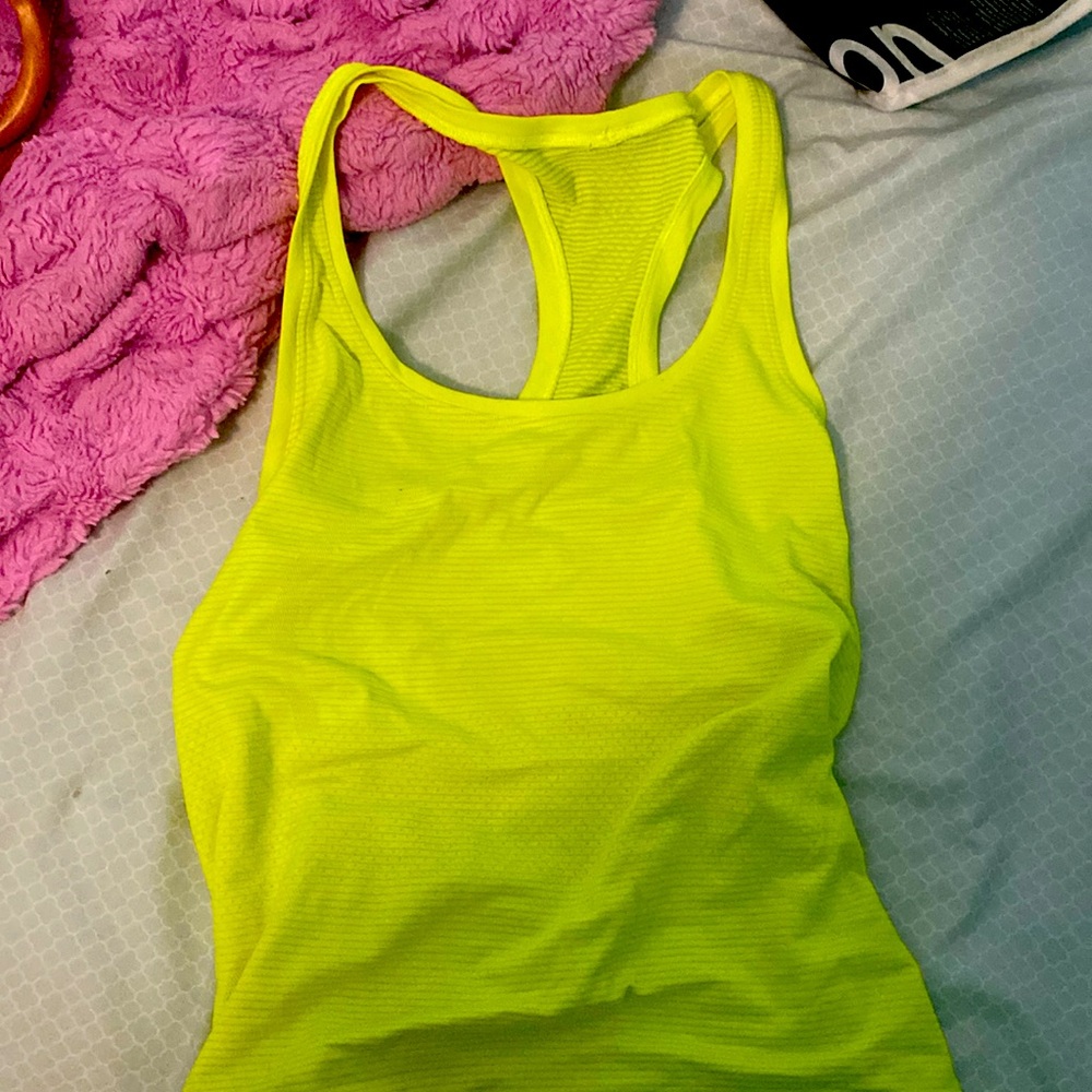 This is a lightly worn lulu lemon tanktop neon yellow